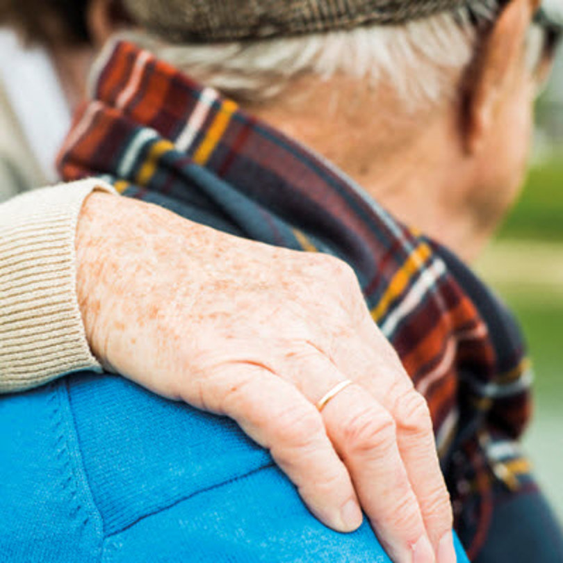 Elderly people supporting each other.