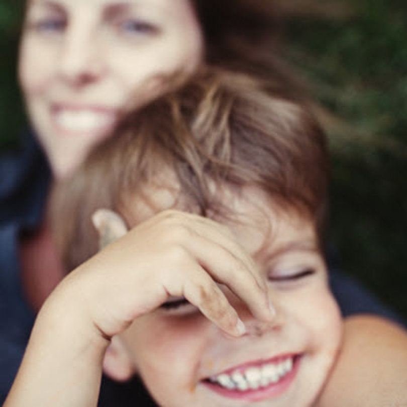 Mother laughing and smiling with her child.
