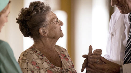 Doctor holding a patients hand