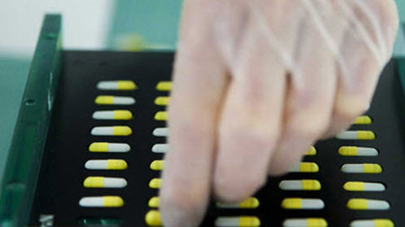 Scientist sorting pills